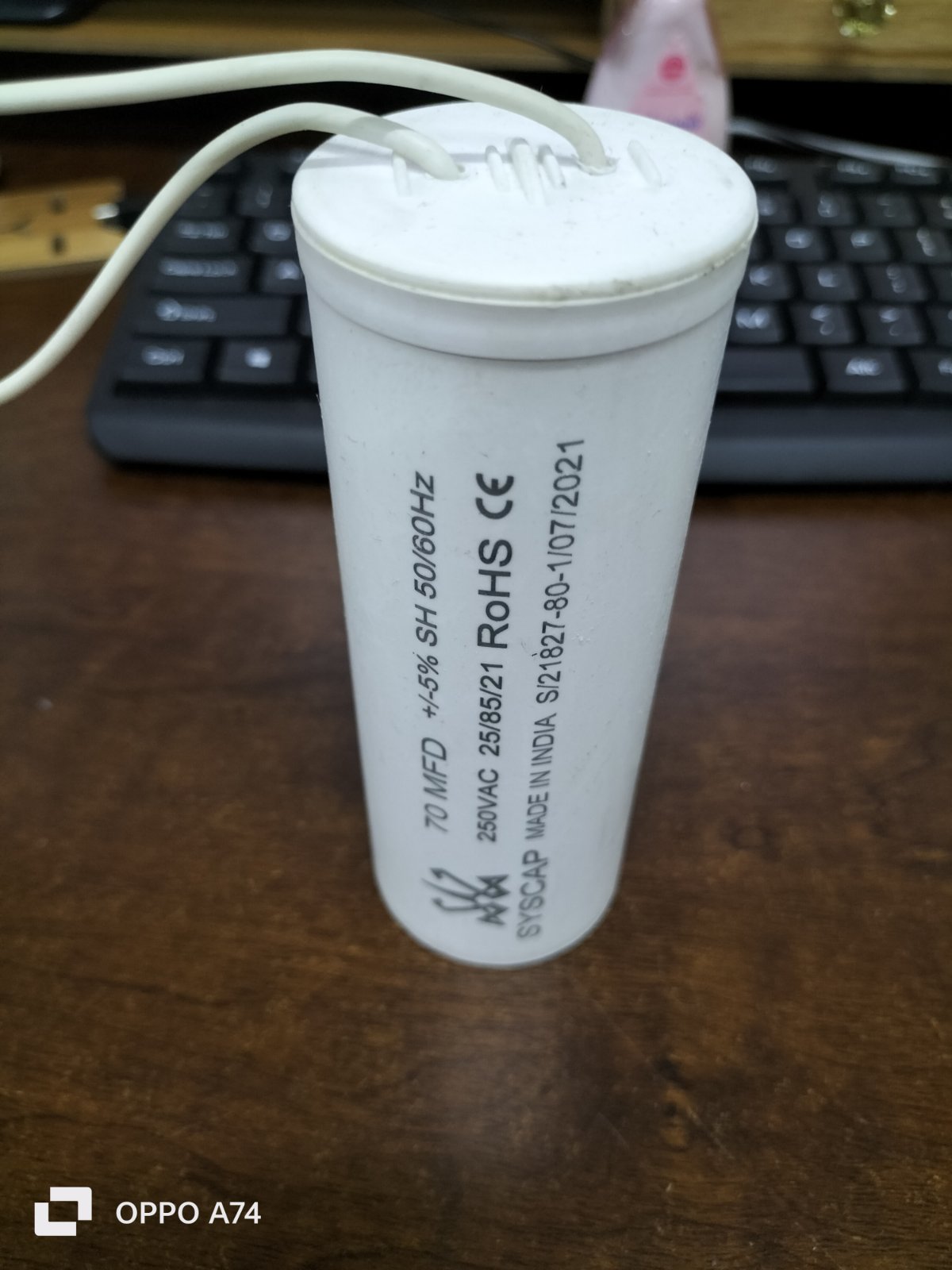 Syscap white motor capacitor with wires for electrical circuitry and parts