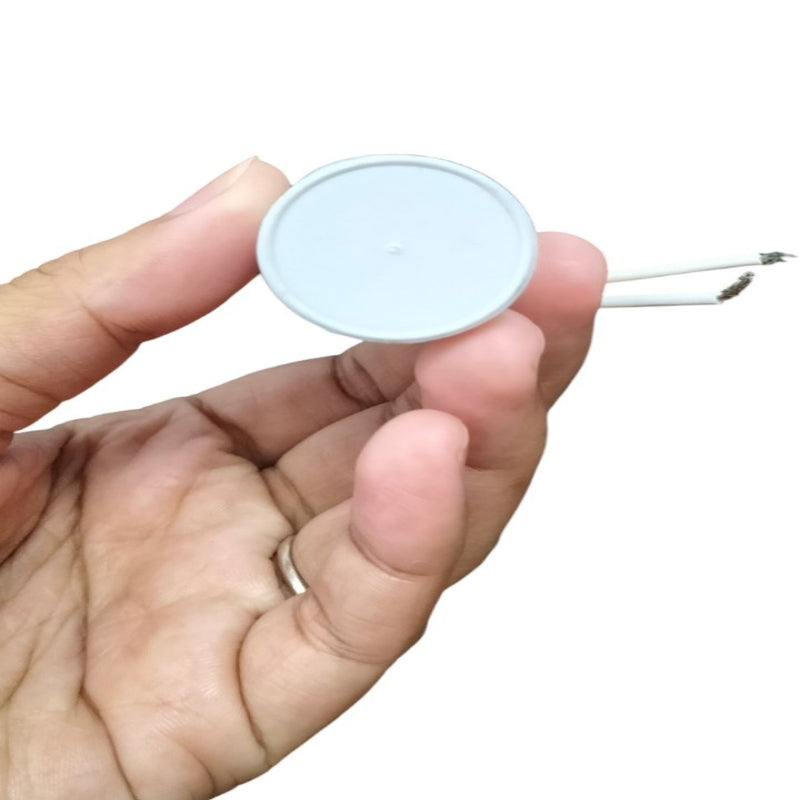 Syscap Motor Running Capacitor 350 VAC held in hand, ideal for electrical circuitry applications