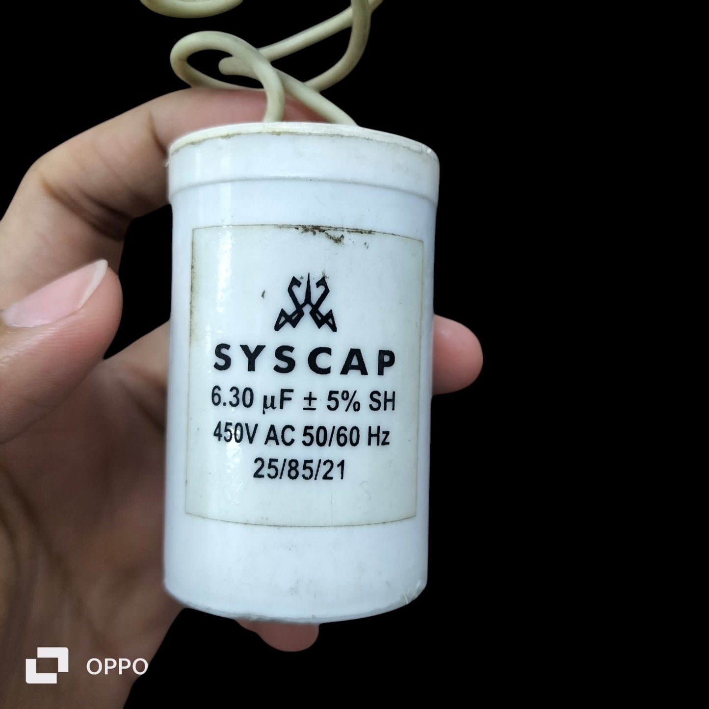 Syscap electrical Run Capacitor 6.30 UF 450VAC held in hand for circuit applications