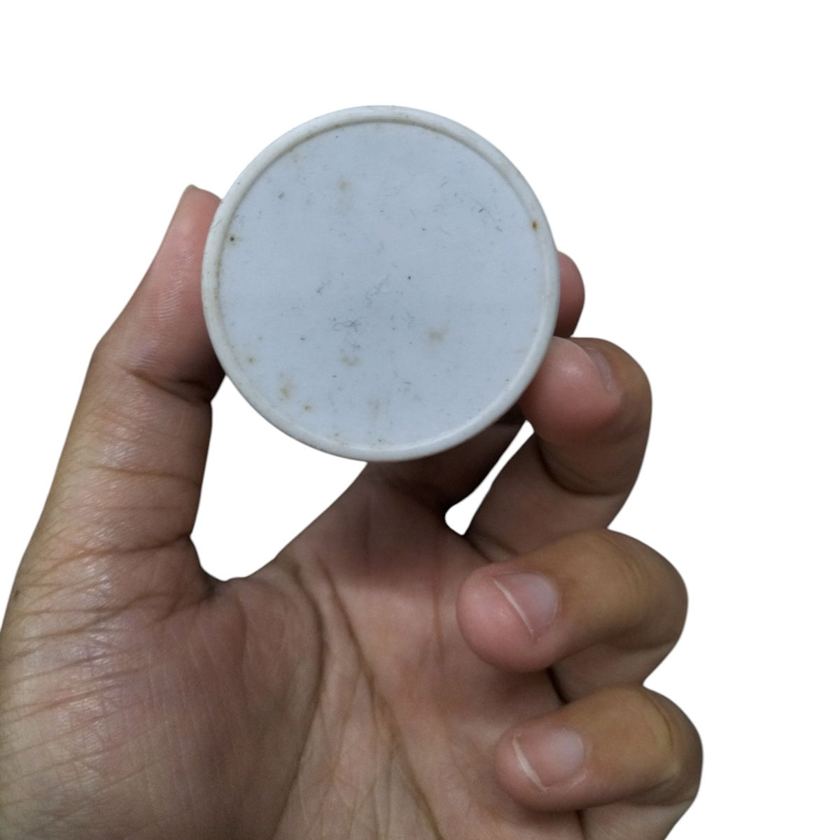 Running Capacitor 18MFD 350 VAC held in hand, featuring a smooth round design for electrical applications