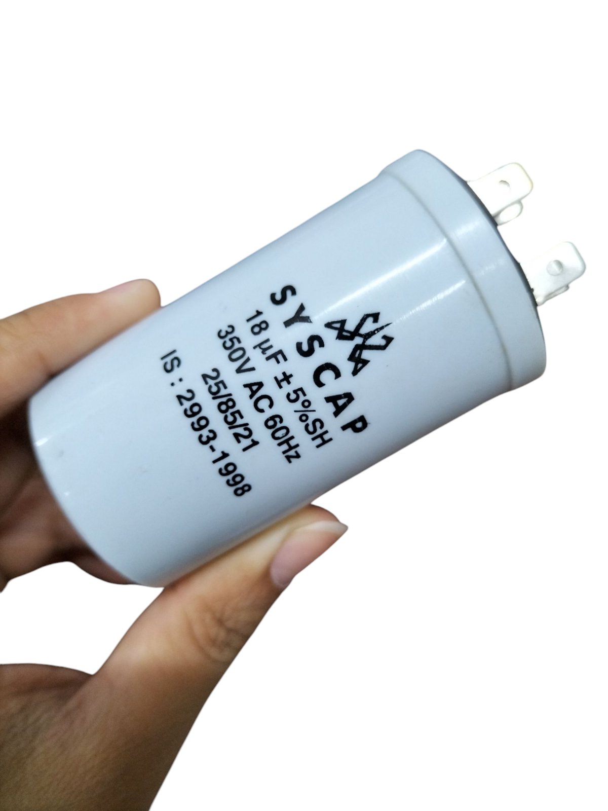 Syscap Running Capacitor 18MFD 350 VAC electrical component held in hand for circuitry use