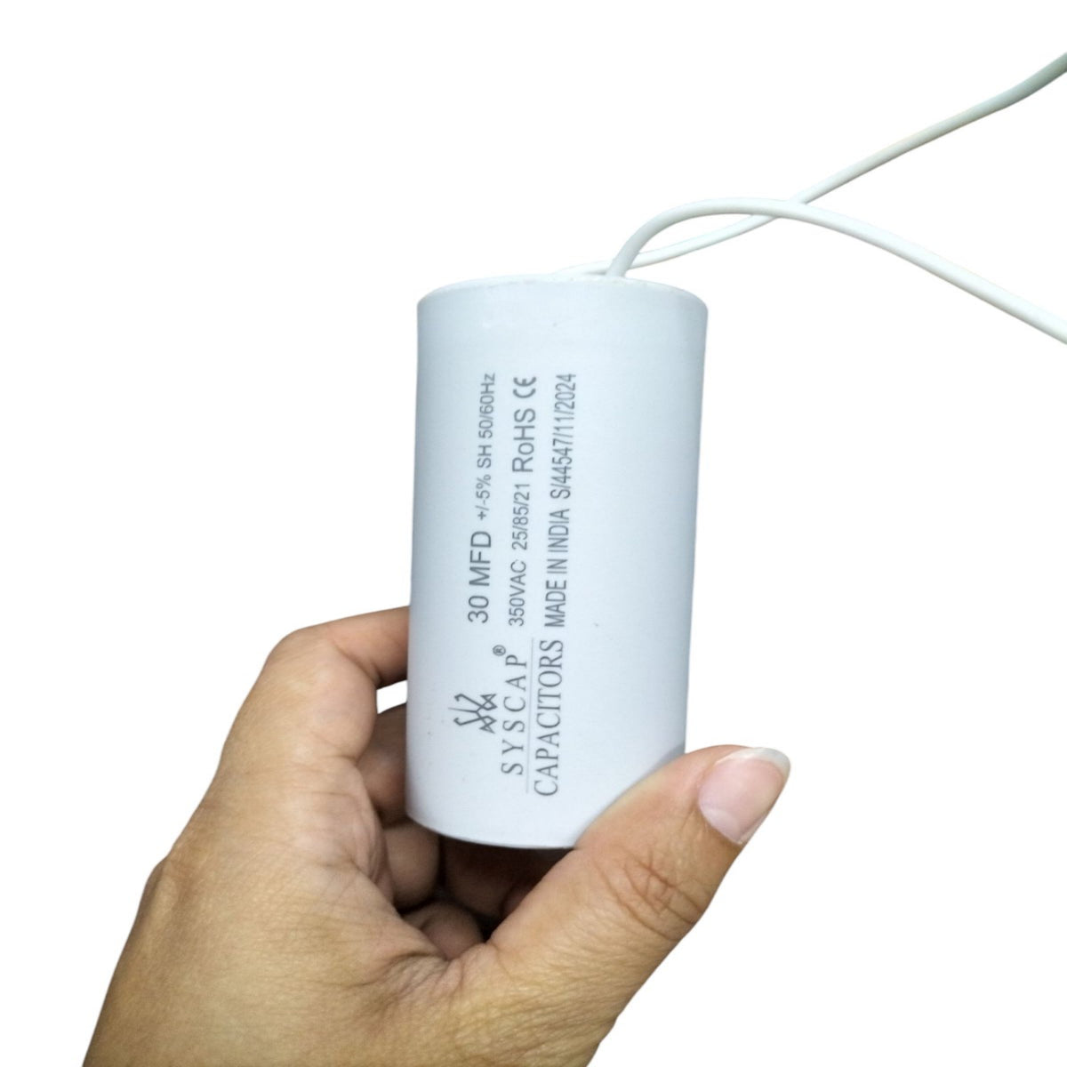 Syscap Running Capacitor 30MFD 350 VAC held in hand, ideal for electrical applications