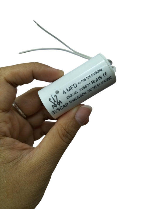 Syscap Running Capacitor 4MFD 250 VAC electrical circuit part held in hand with white casing and wires