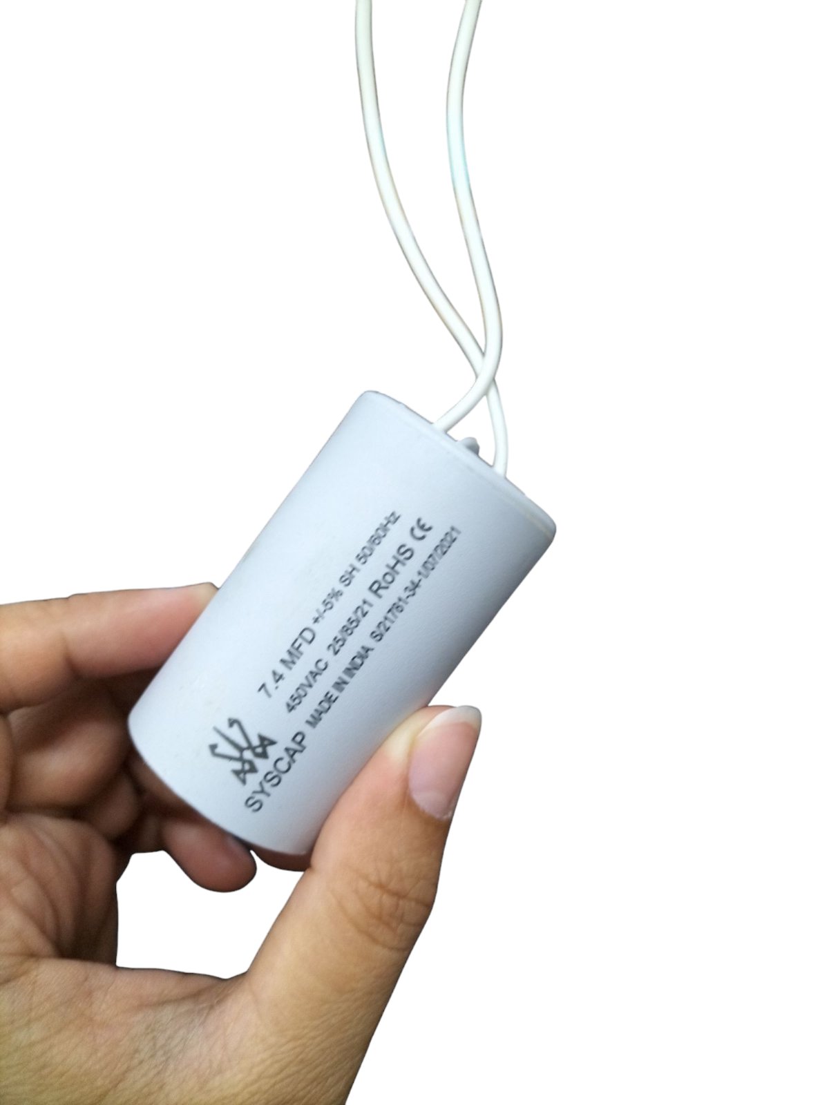 Syscap Running Capacitor 7.4MFD 450 VAC held in hand with white cylindrical body and wires
