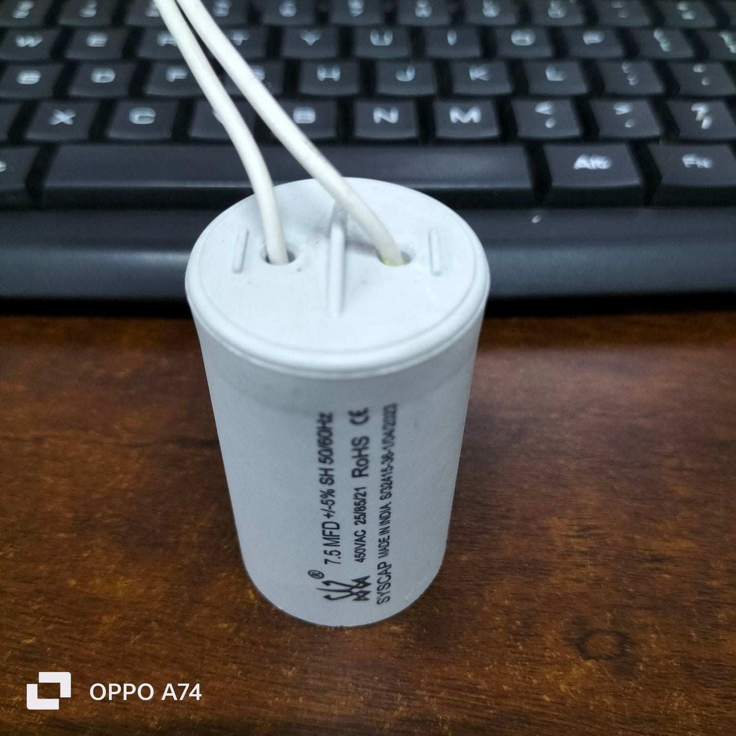 Syscap Running Capacitor 7.5MFD 450 VAC white cylindrical electrical component with two white wires