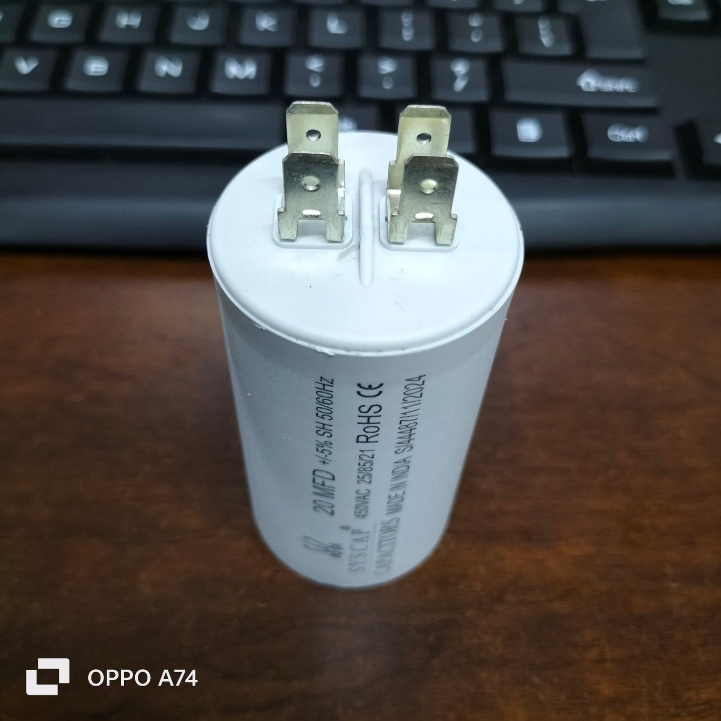 Syscap Motor Capacitor with three metal terminals on white cylindrical body