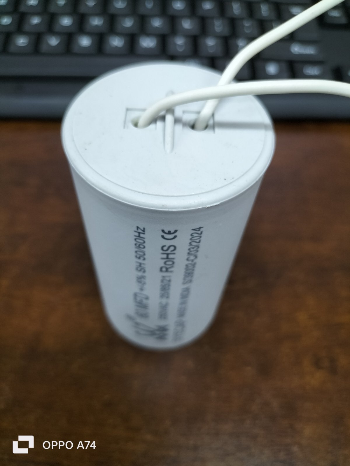 Syscap motor capacitor with white wires for electrical circuitry and parts
