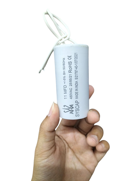 Syscap 11MFD 450 VAC Running Capacitor held in hand with white wires for electrical circuits