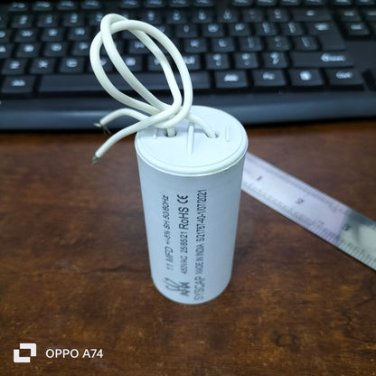 Syscap 11MFD 450 VAC Running Capacitor cylindrical electrical component with white wires on wooden surface
