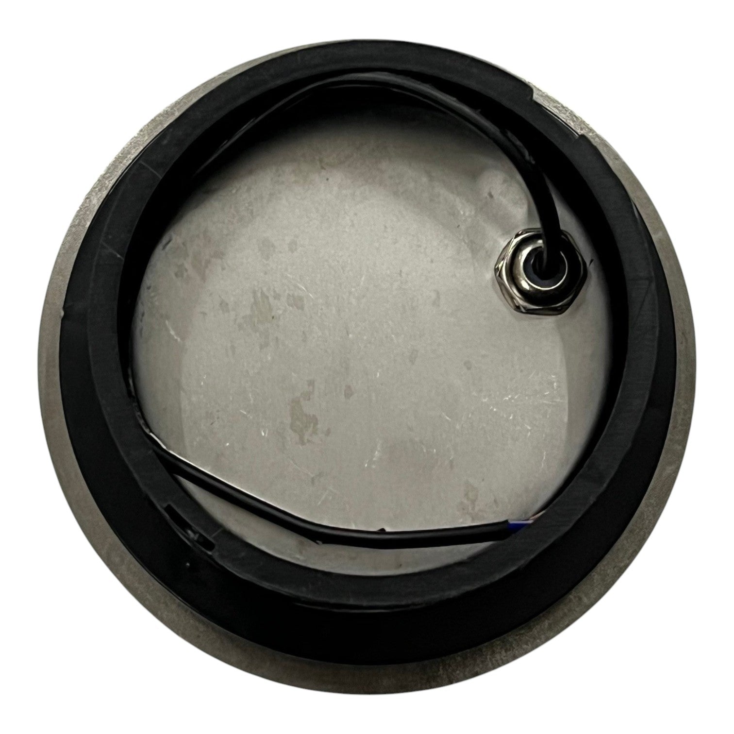 Metallic component with a black rim on a white background