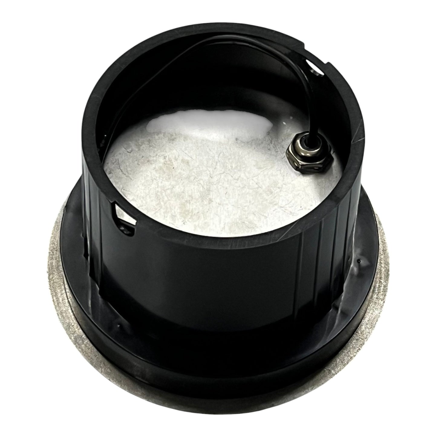 Black metal component with white powder inside on a white background