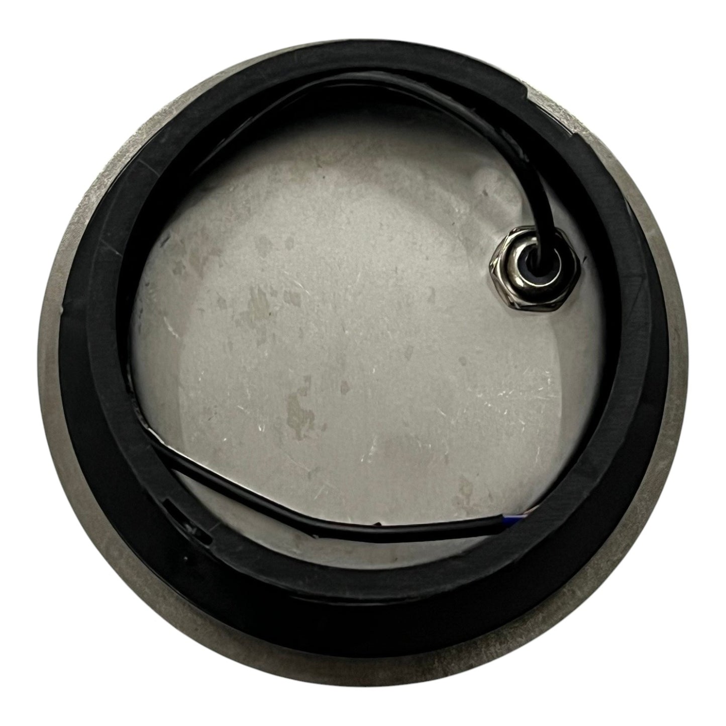 Metallic component with a black rim on a white background