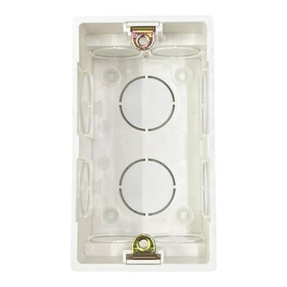 A white plastic double-gang wall switch box with two circular terminal circles and gold-colored screw terminals, shown against a plain white background.