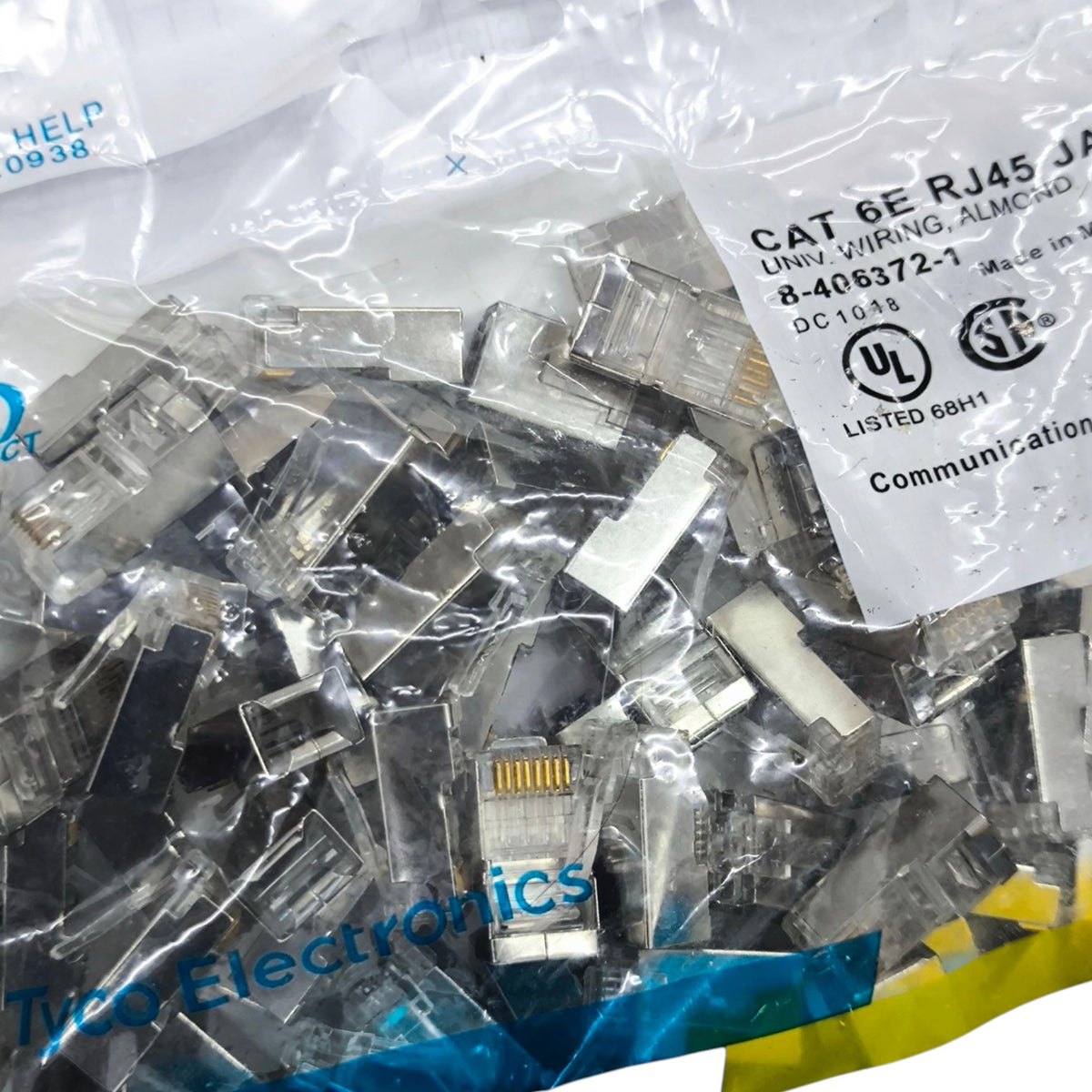 A bulk bag of Tyco Electronics CAT 6E RJ45 Jack Shunts in clear plastic packaging with a white printed label.