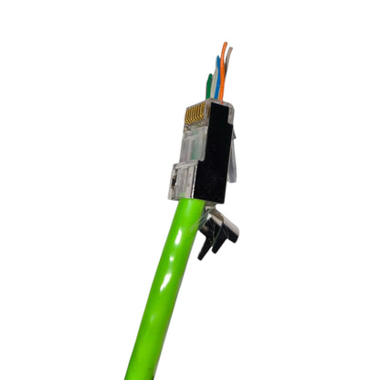 A close-up of a green Ethernet cable with a RJ45 connector showing four colored wire pairs and gold-plated contacts, secured with a black tape and clip, on a white background.