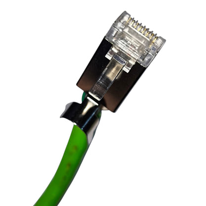 Close-up of a green Ethernet cable with a clear RJ45 connector and black metal shielding on a white background.