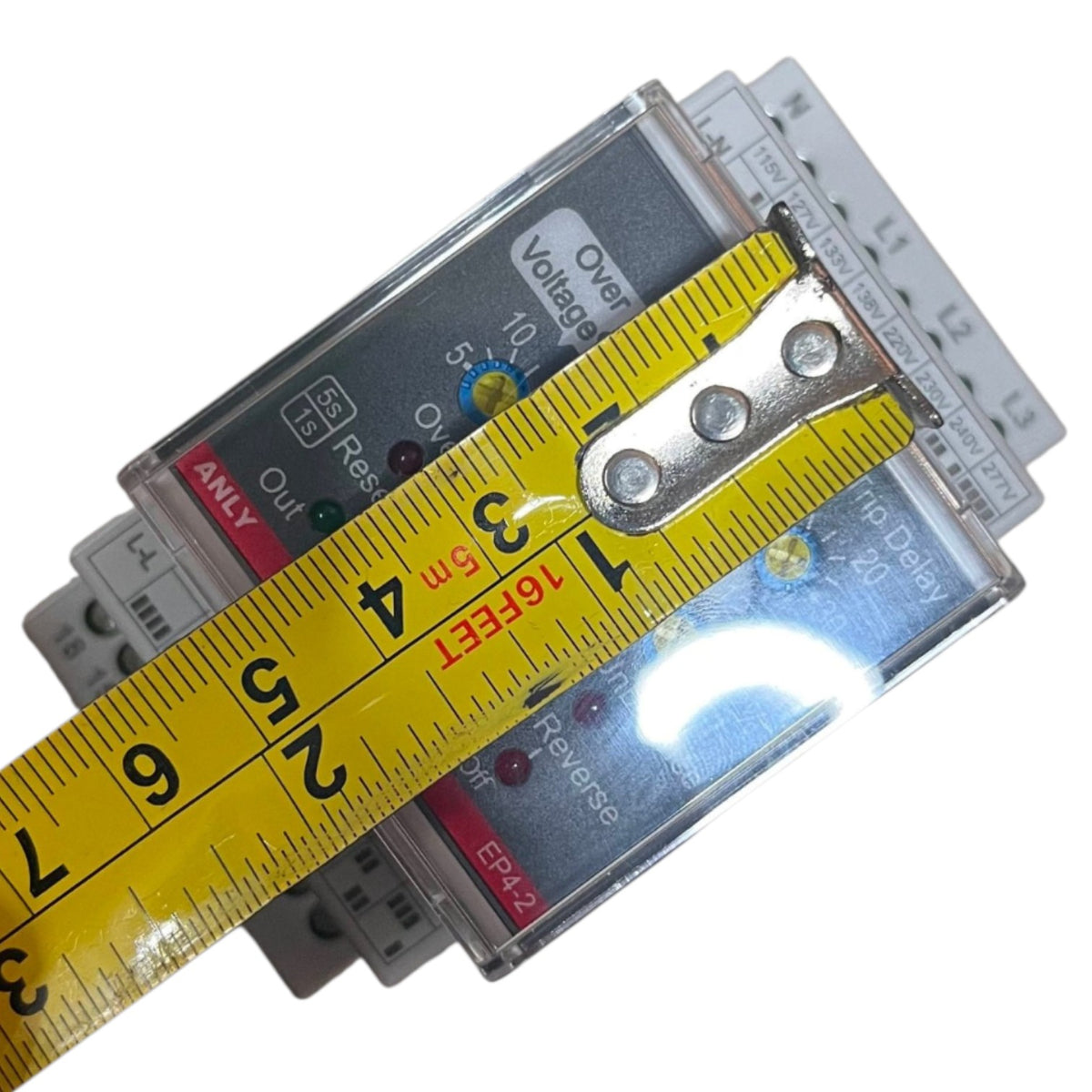 A close-up of a yellow tape measure laid across a stack of electrical surge protectors to show their dimensions, on a plain white background.