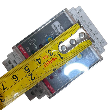 A close-up of a yellow tape measure laid across a stack of electrical surge protectors to show their dimensions, on a plain white background.