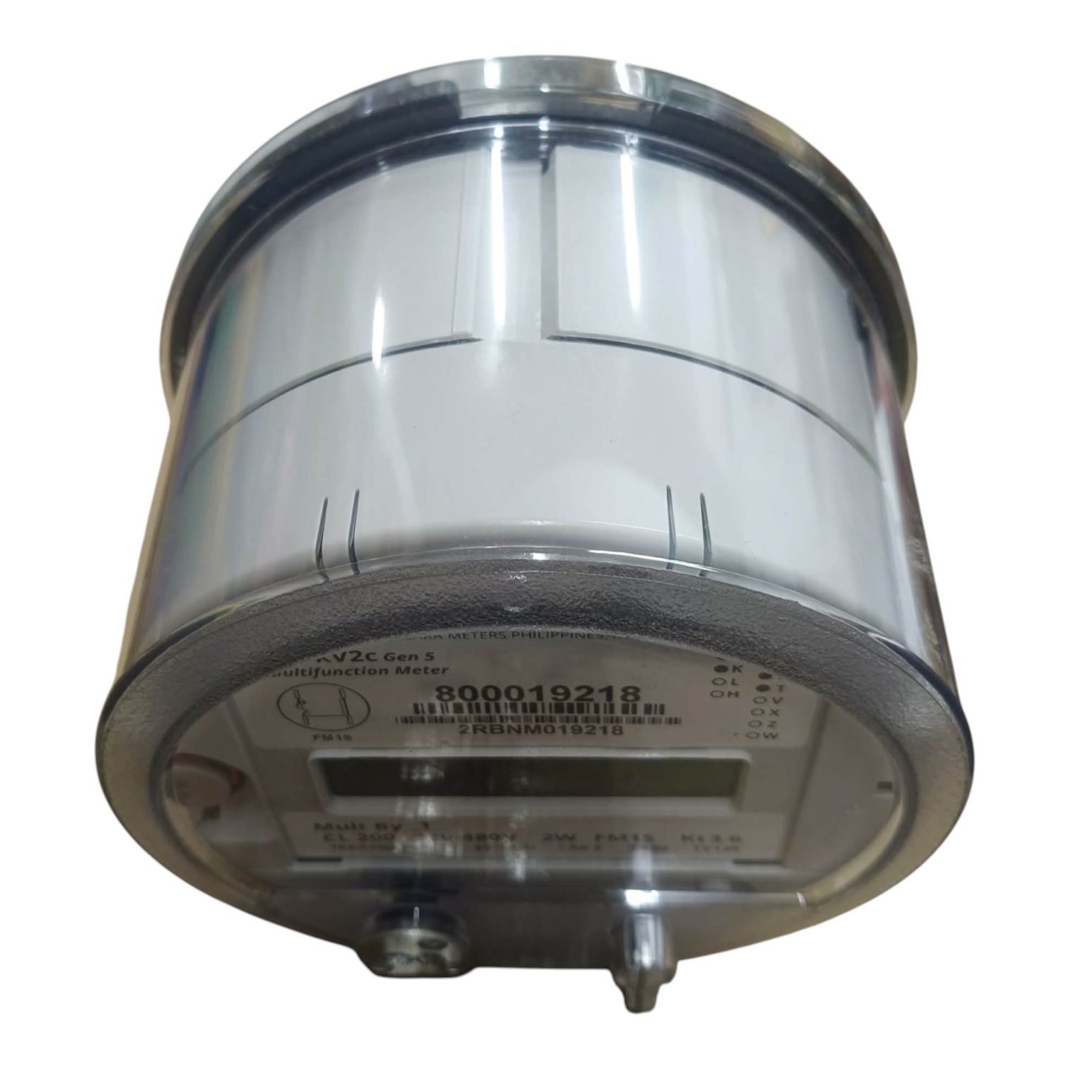 A cylindrical industrial digital watt-hour meter with a transparent protective cover and metallic silver body, featuring a digital display window and terminal connectors.