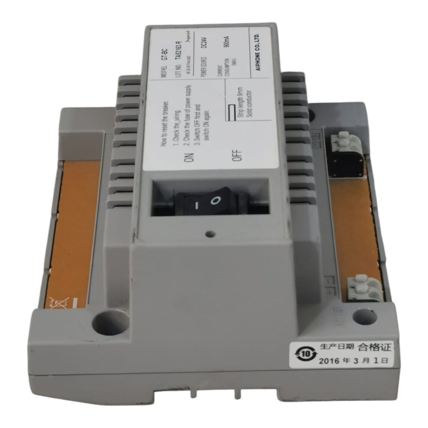 A gray industrial electronic module with a white label, black switch, and orange terminal strips on a white background.