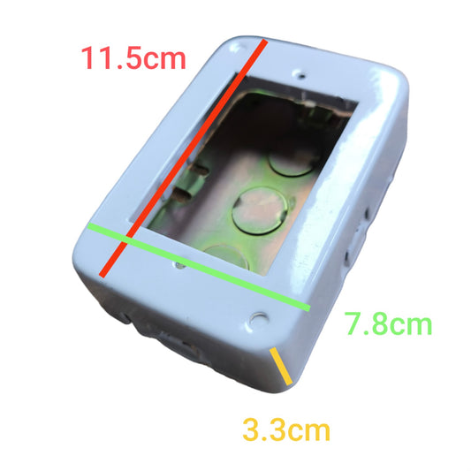 A light gray electrical junction box or socket cover shown on a white background with red, green, and yellow dimension lines and text labels indicating measurements of 11.5cm, 7.