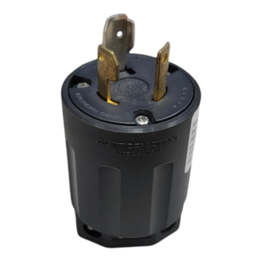 A black three-prong American Denim electrical outlet plug with gold-toned metal pins, shown on a plain white background.