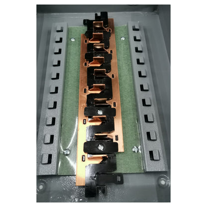 Electronic component with copper and black metal parts on a green and gray background