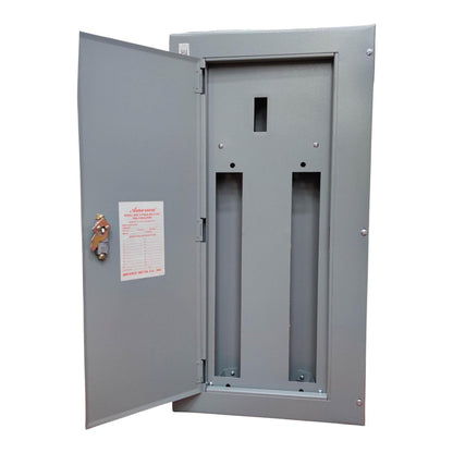 A gray metal electrical panel with its door open, showing two vertical mounting slots and a small white instruction sheet attached to the door.