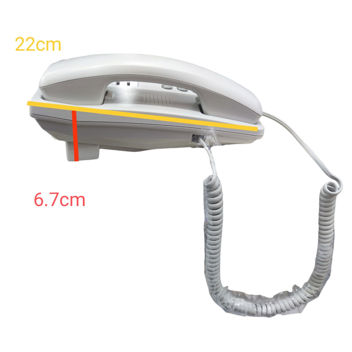 A white and gray landline telephone with a coiled cord, shown on a plain white background with overlaid dimension labels reading 22cm and 6.7cm.
