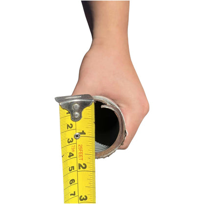 A hand holding a metal pipe or tube against a white background, with a yellow tape measure extended into the opening to show its diameter in inches.