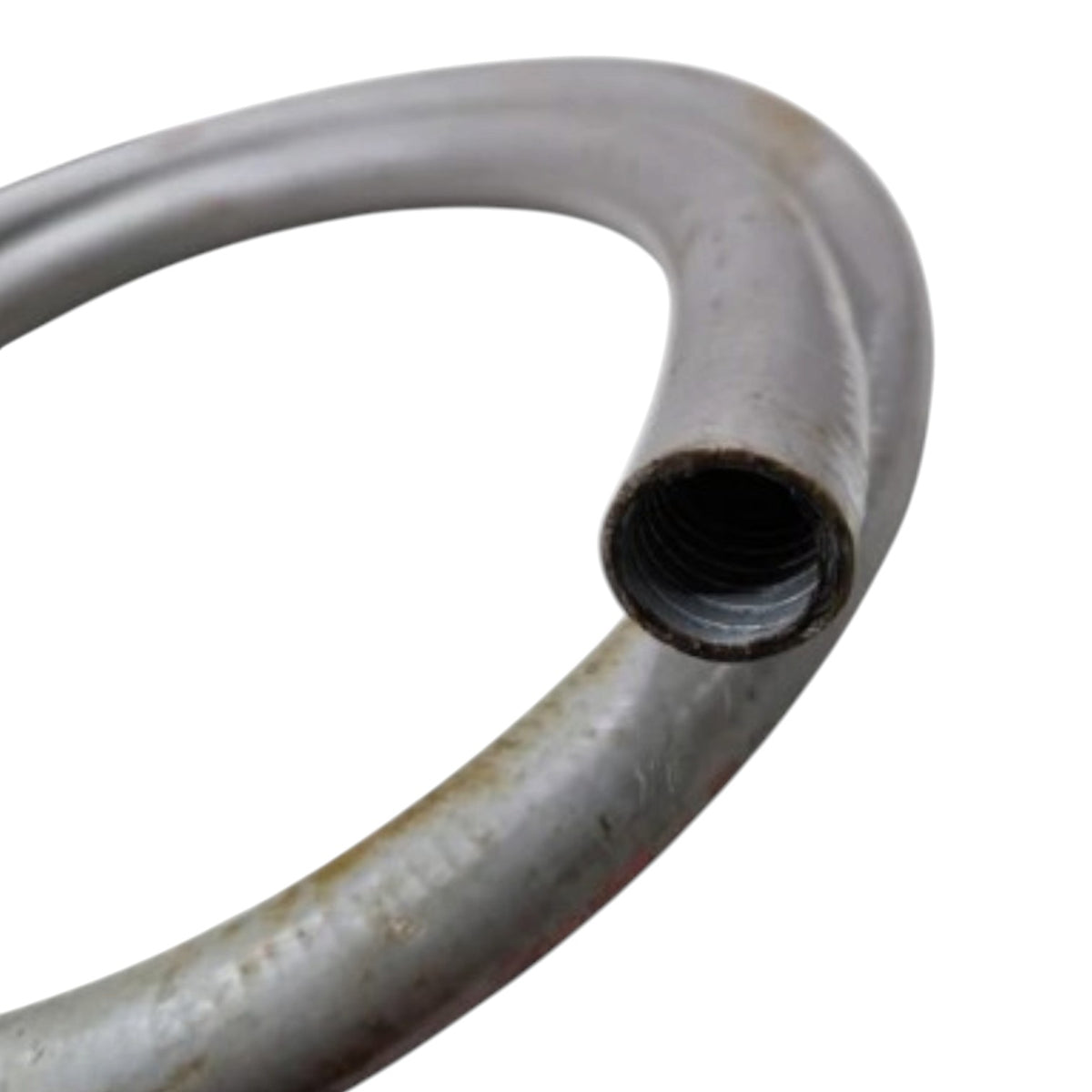 A close-up of a curved metal pipe or hose with a threaded female end, showing a weathered silver-gray surface with some rust and dirt, isolated on a white background.