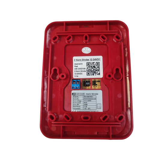 A red plastic electrical junction box cover with two white labels and a blue terminal connector, photographed on a solid white background.