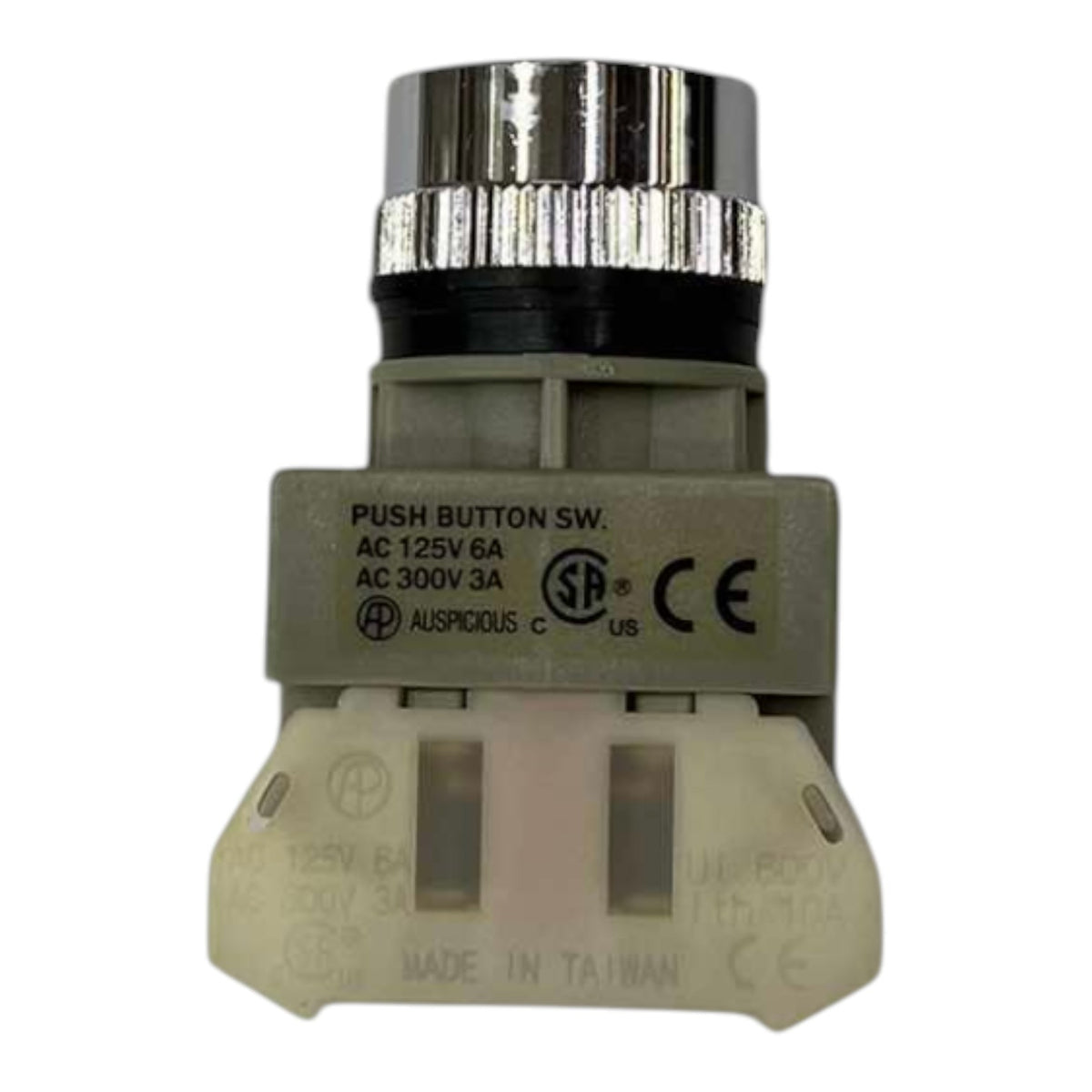 An industrial push button switch module with a silver metal top, black collar, gray plastic body, and beige plastic base, featuring printed specifications and certification marks.
