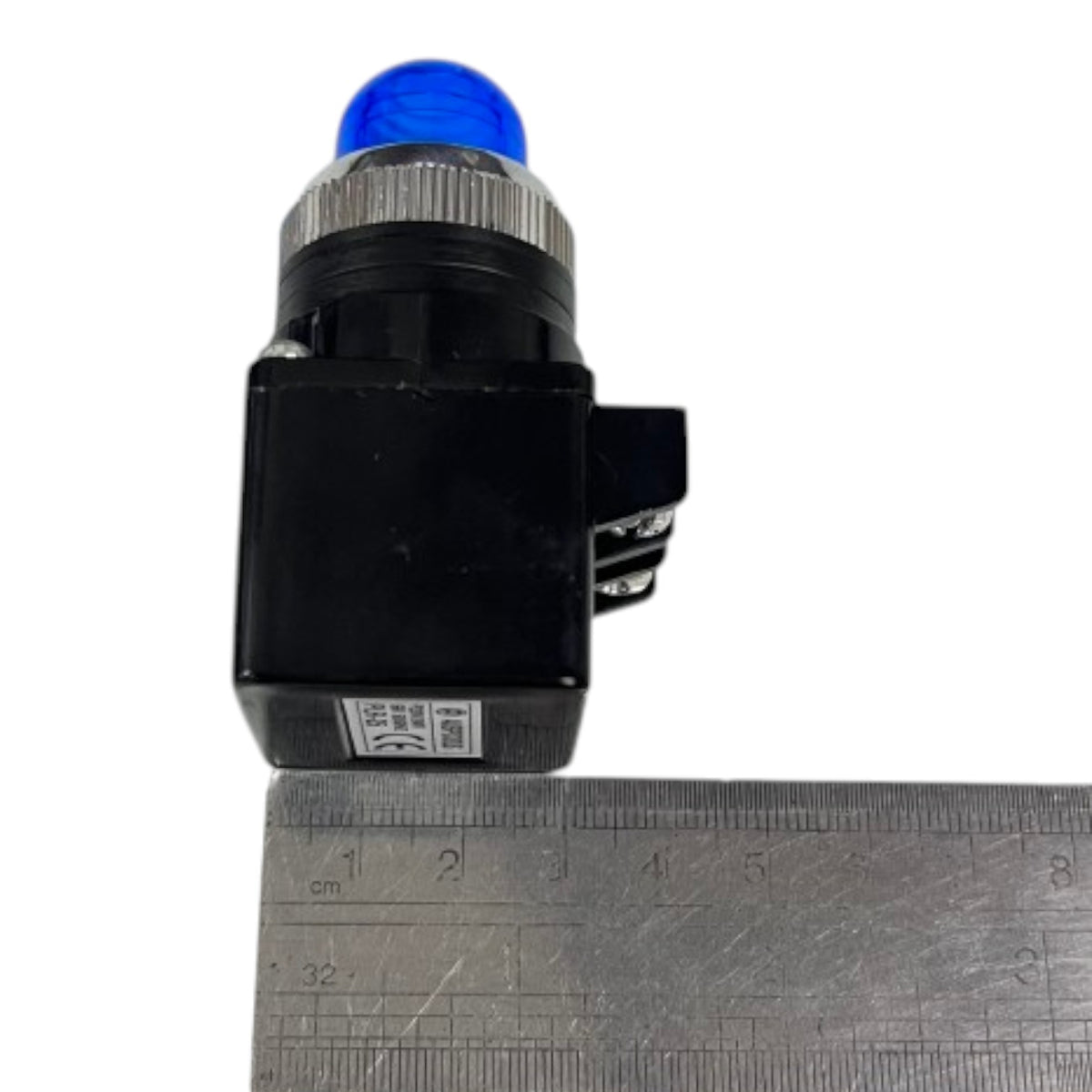 A small black electronic component with a blue dome-shaped top and a silver ribbed collar, shown next to a metal ruler for scale on a white background.