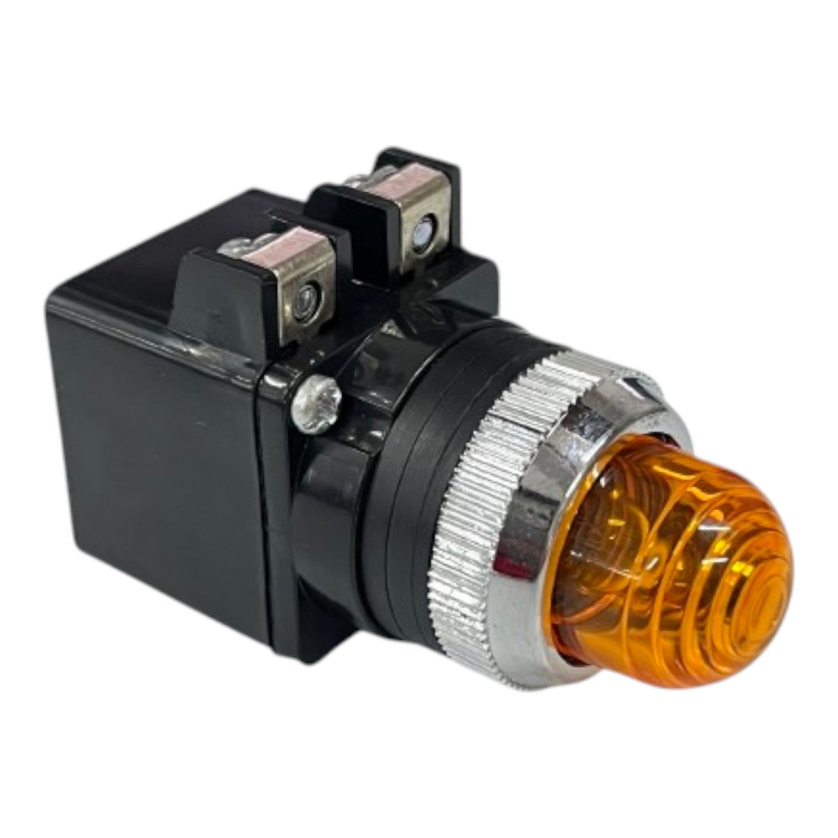 An industrial electrical push-button switch with a black plastic housing, a silver knurled bezel, and an amber orange translucent lens.