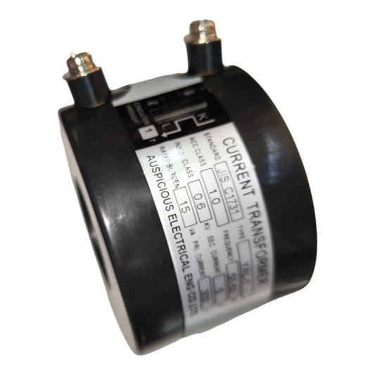 A cylindrical black current transformer with two metal terminal posts and a white technical specification label, shown on a plain white background.