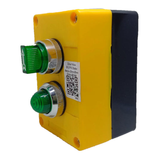 A yellow and black industrial electrical box containing two green push buttons with silver metal bezels, shown on a plain white background.