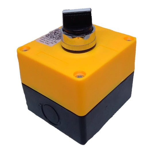 A square industrial electrical component with a yellow top casing and a black bottom casing, featuring a black rotary knob with a chrome collar on top, set against a plain white background.