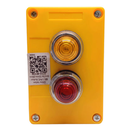 A yellow industrial push button box with two round front covers, one amber/yellow and one red, mounted on a white background with a product label sticker on the left.