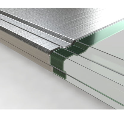 Close-up of a stack of transparent glass panels with a brushed silver metal edge and a green protective film or backing visible along the side.