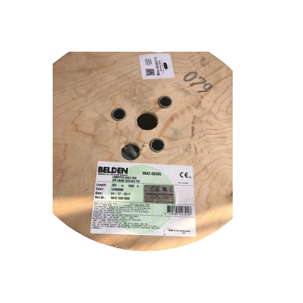 A Beldens wood spool, likely for a fire starter or similar material, with a white label showing product details and the number 079 handwritten on the wood.