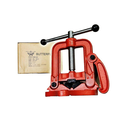 A red pipe vise with a black handle and screw mechanism, shown next to its cardboard packaging box labeled 'BUTTERFLY'.