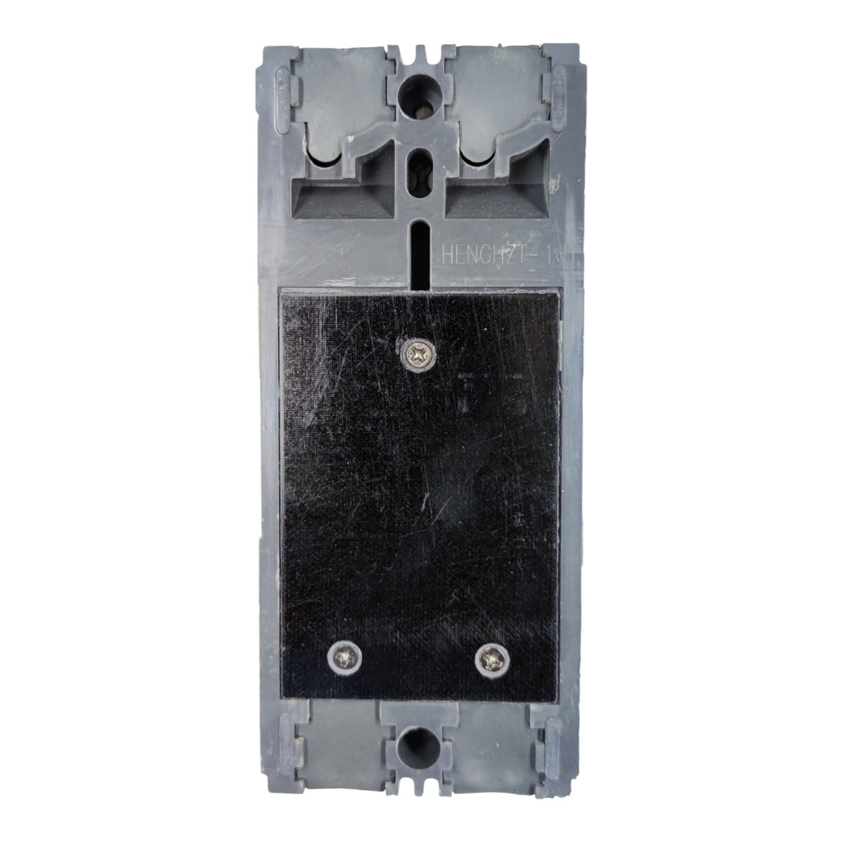 A gray plastic electrical component or switch module with a large black rectangular panel secured by screws, shown against a plain white background.