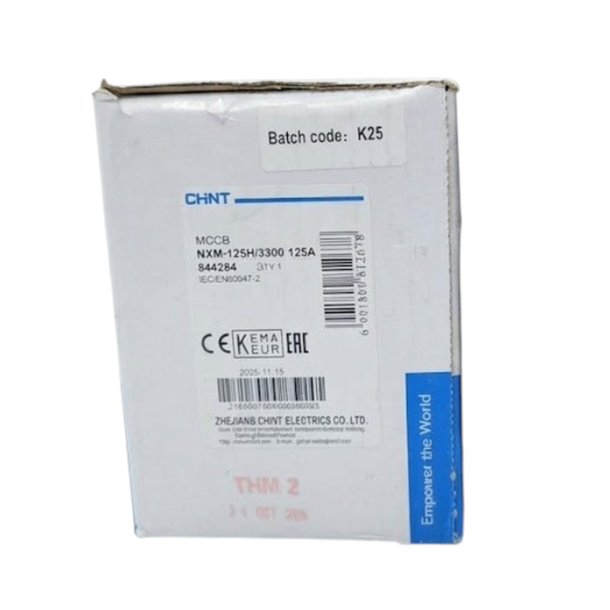 A white cardboard product box for CHNT MCCB NVM-125H 3300 125A, showing printed specifications, barcodes, and a blue vertical banner on the side.
