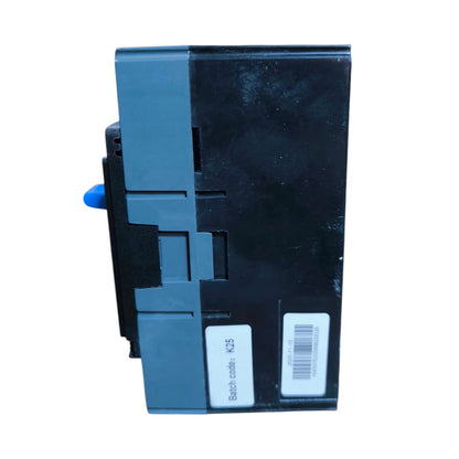 A black and dark gray electrical component or module with a small blue switch protruding from the side, shown against a plain white background. Two white labels are attached to the front face.