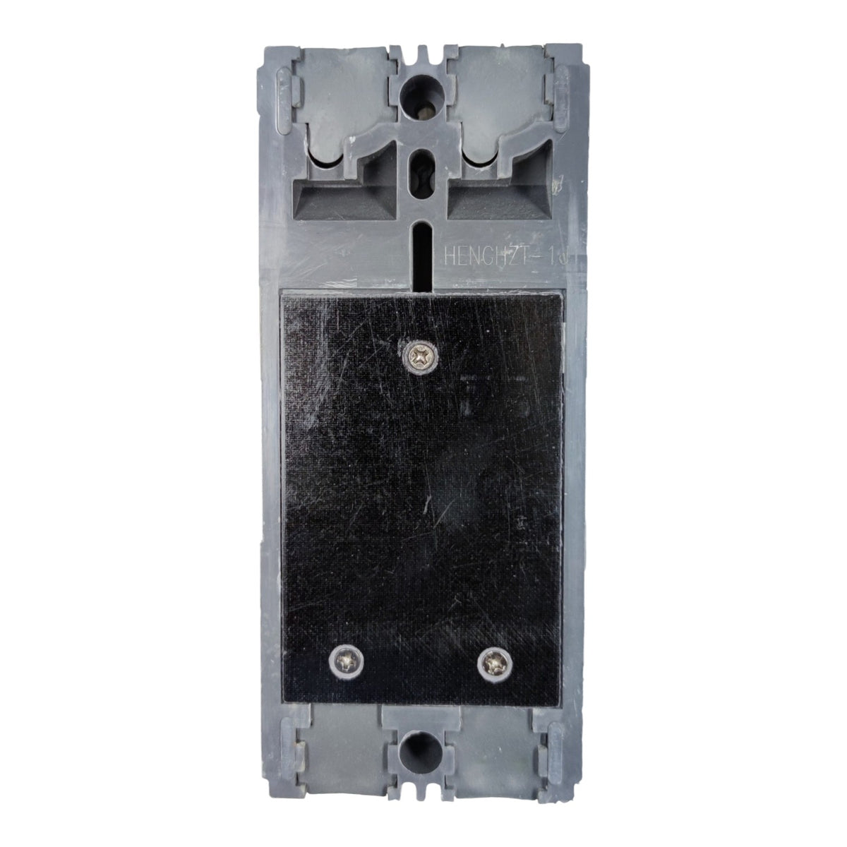 A gray plastic electrical component or switch module with a large black rectangular panel secured by two screws, photographed against a plain white background.