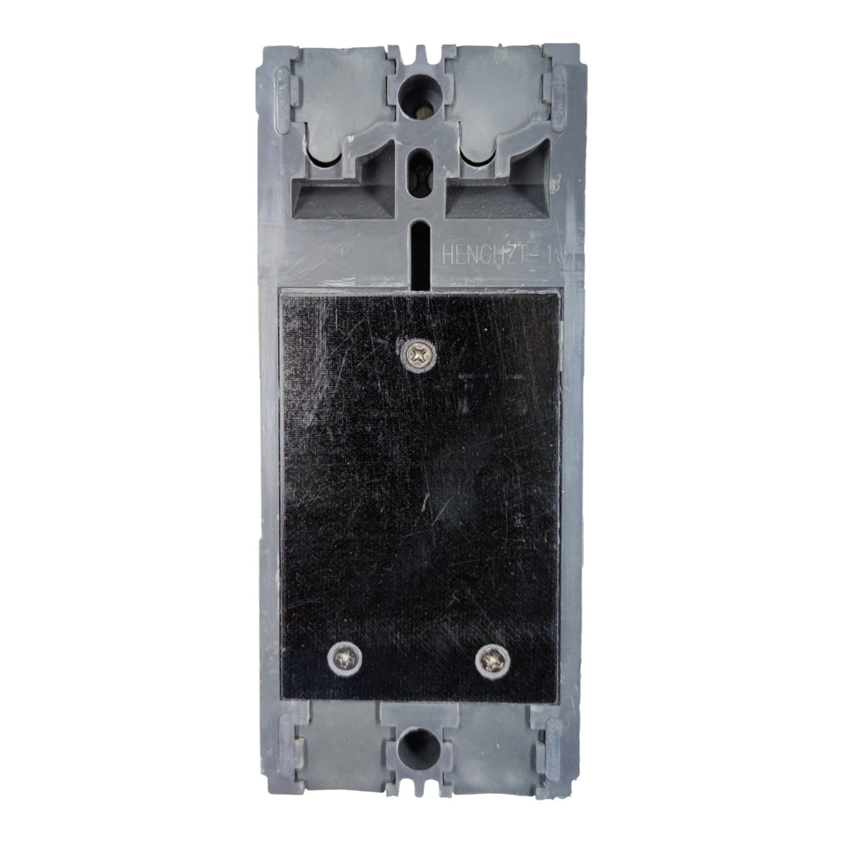 A gray plastic electrical component or switch module with a large black rectangular panel secured by two screws, photographed against a plain white background.