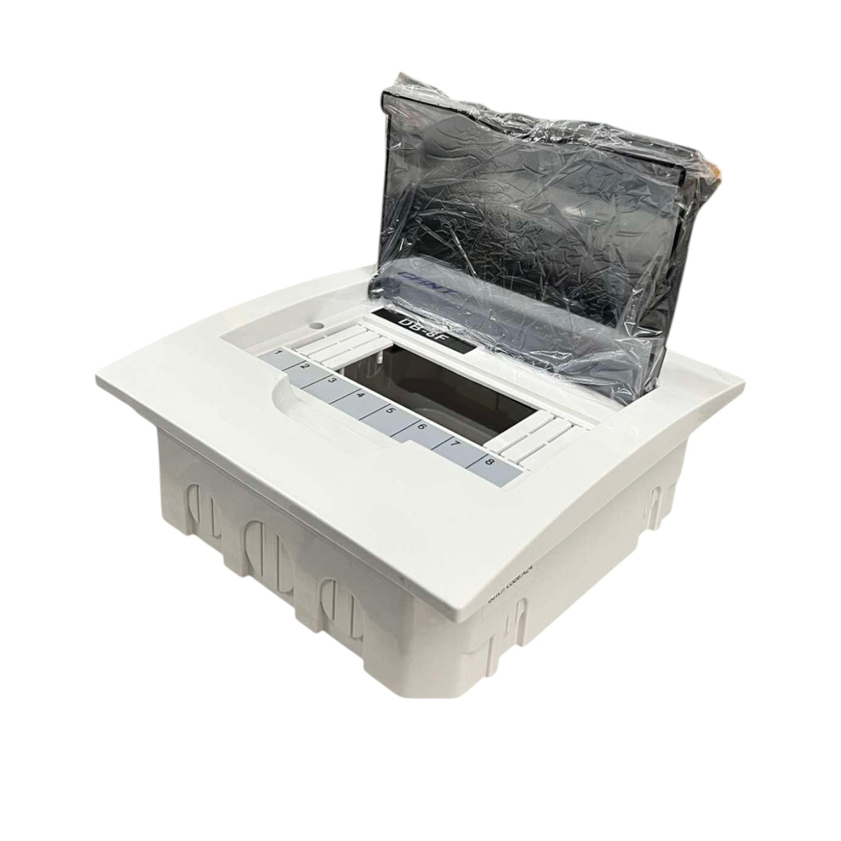 A white plastic pop-up utility access cover with a hinged lid, shown with the lid partially open and wrapped in protective plastic. The unit features a recessed base with molded details and a central opening.