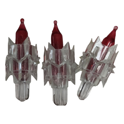 Three clear arrow nocks with red tips on a white background