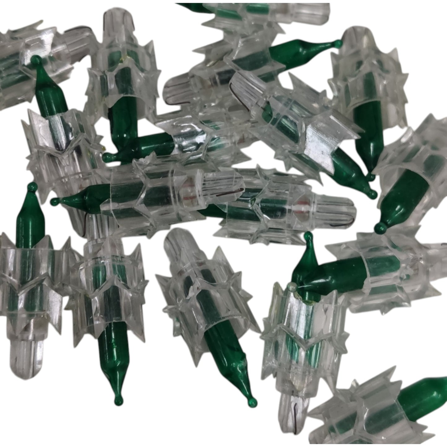 Collection of green and clear plastic components on a white background